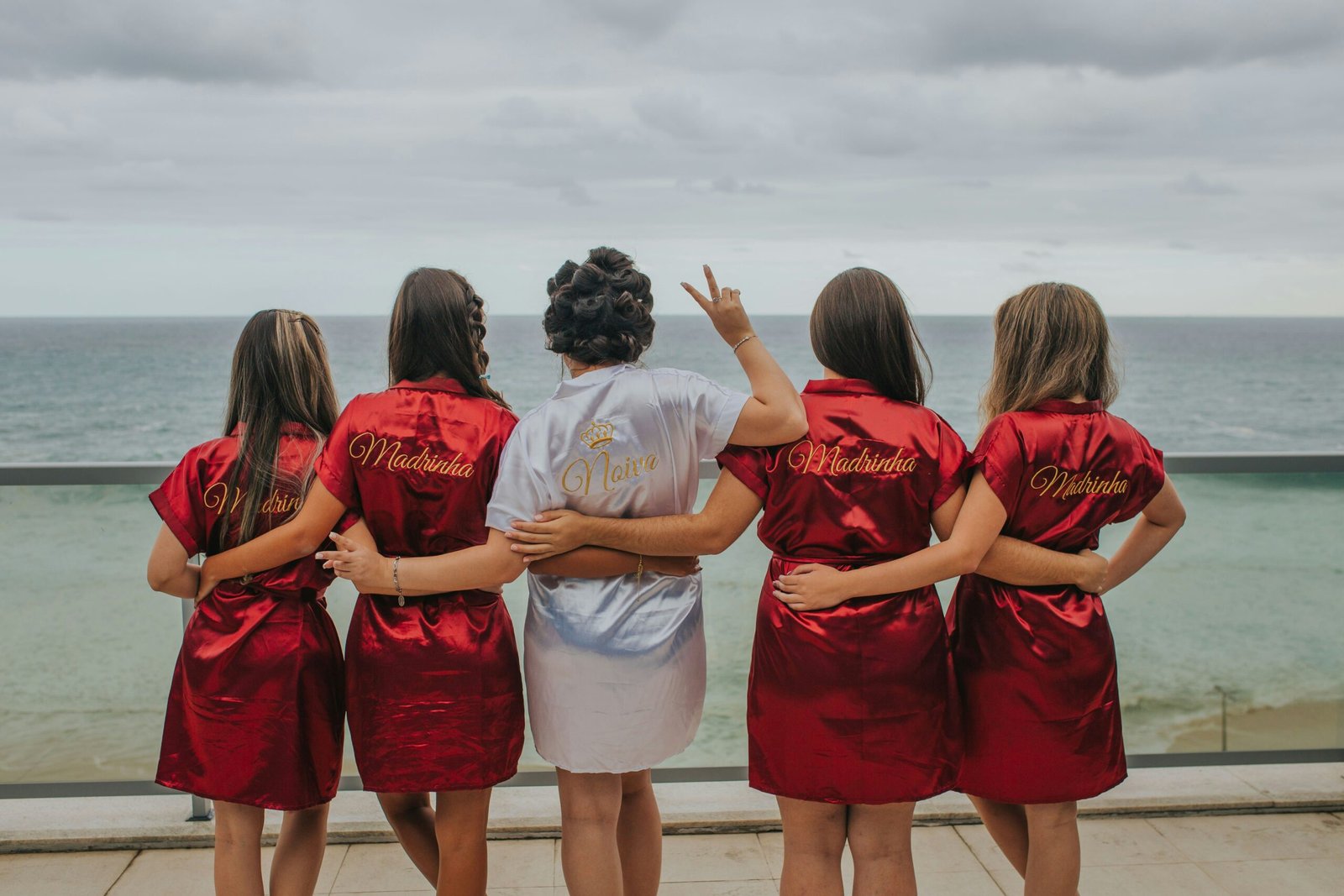 brides and bridesmaid looking at the back